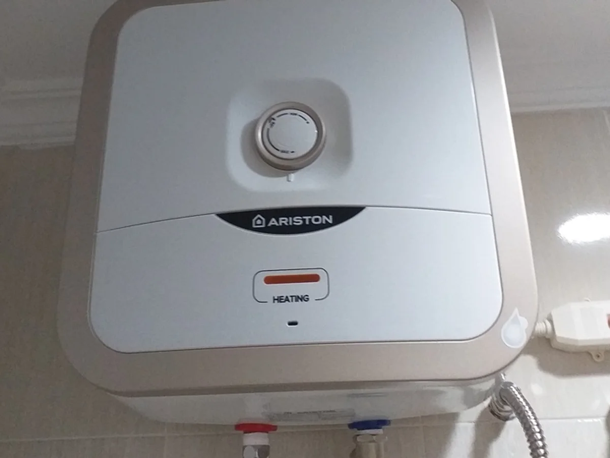Technician servicing a home geyser