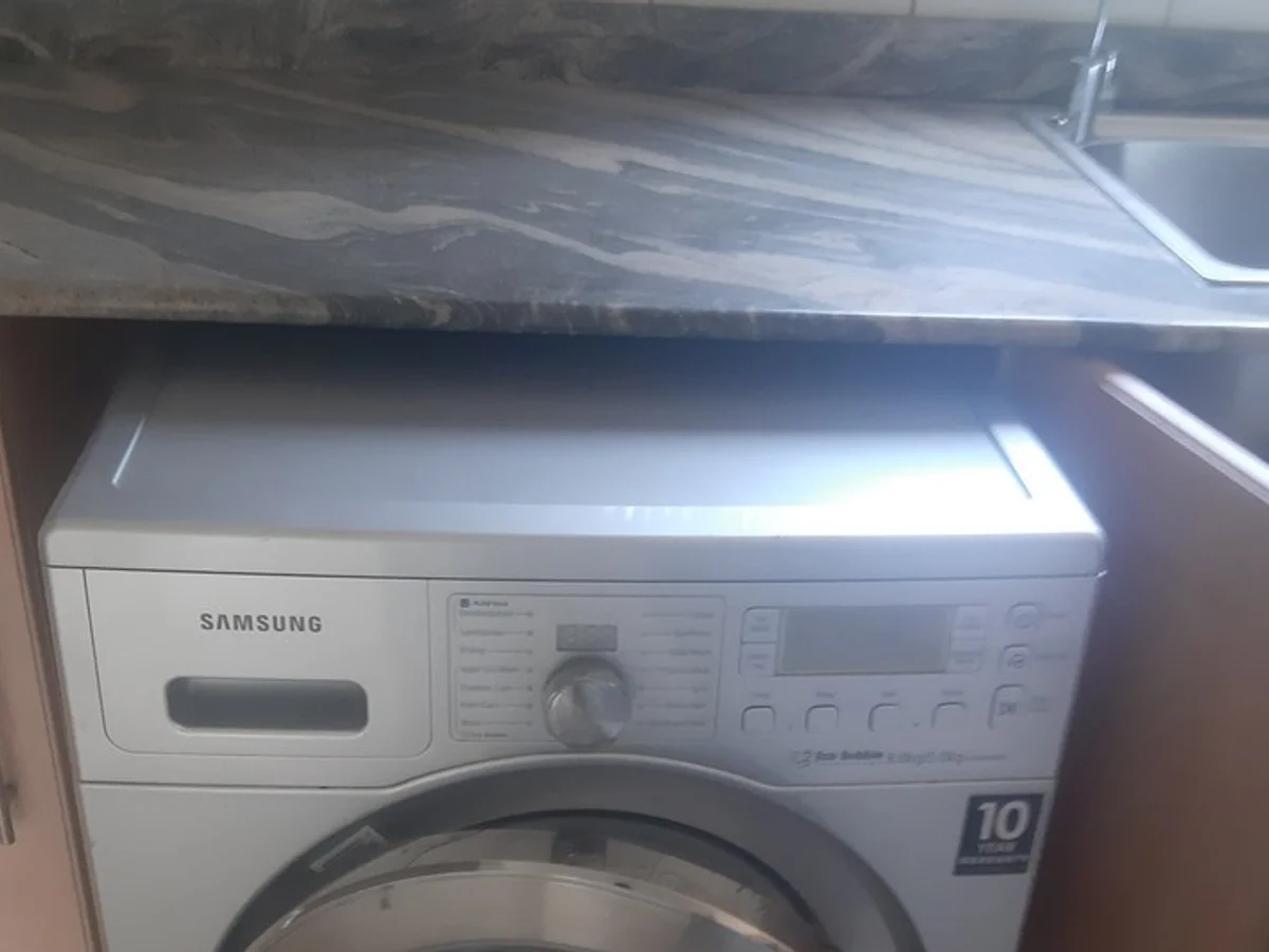 Technician servicing a washing machine